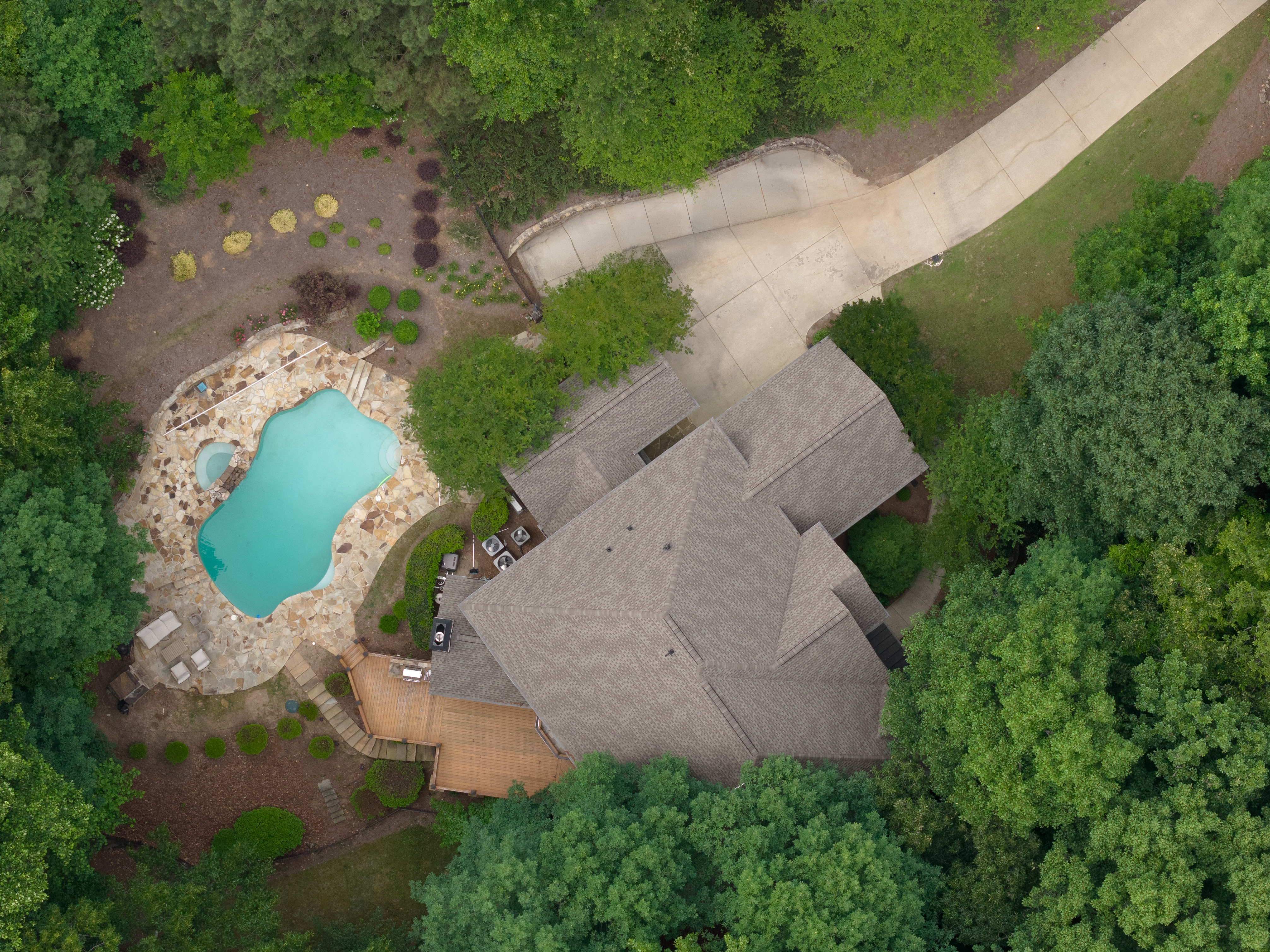 Property overhead — pool, flagstone terrace, cedar deck and driveway