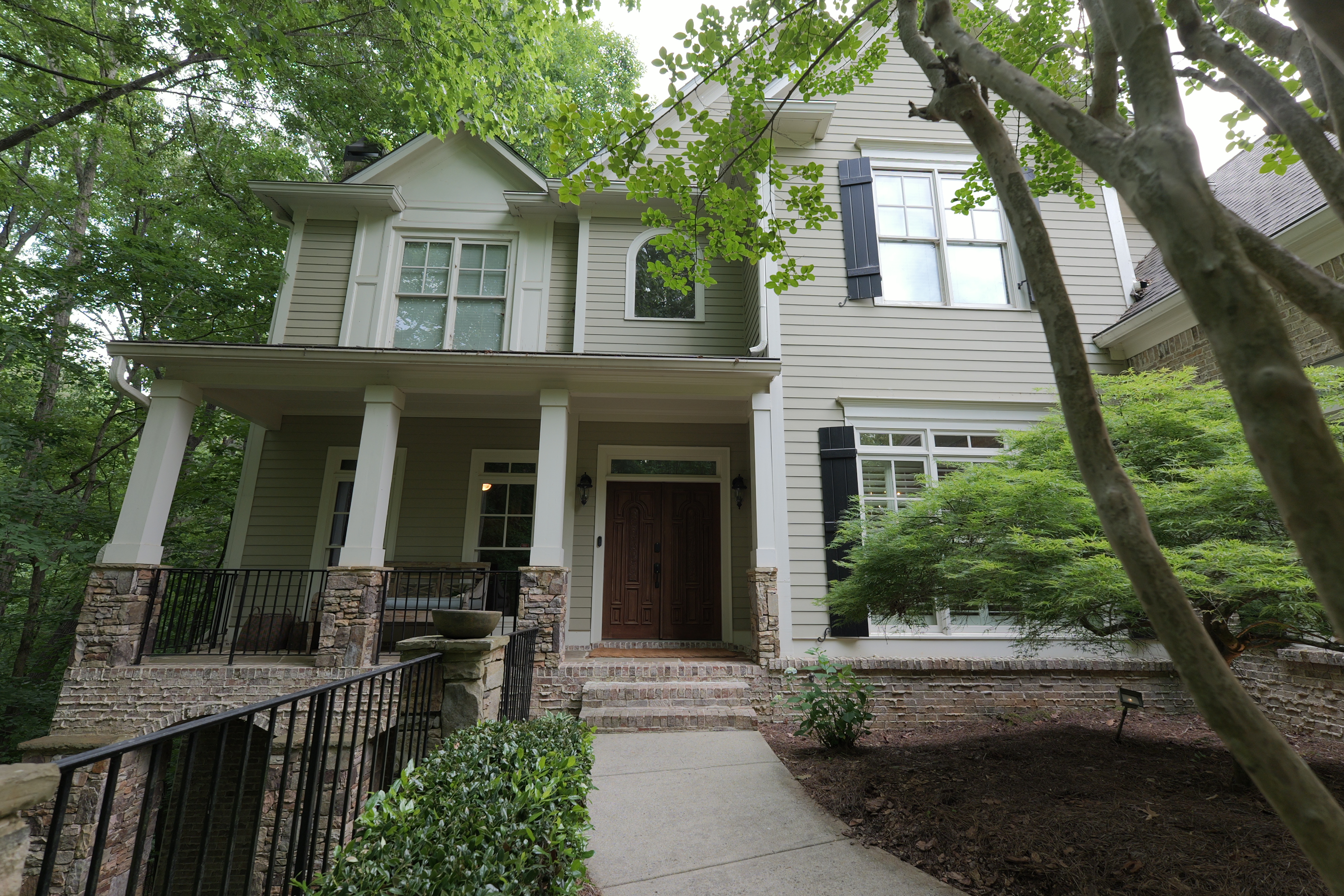 Full facade — carved double doors, columns, canopy