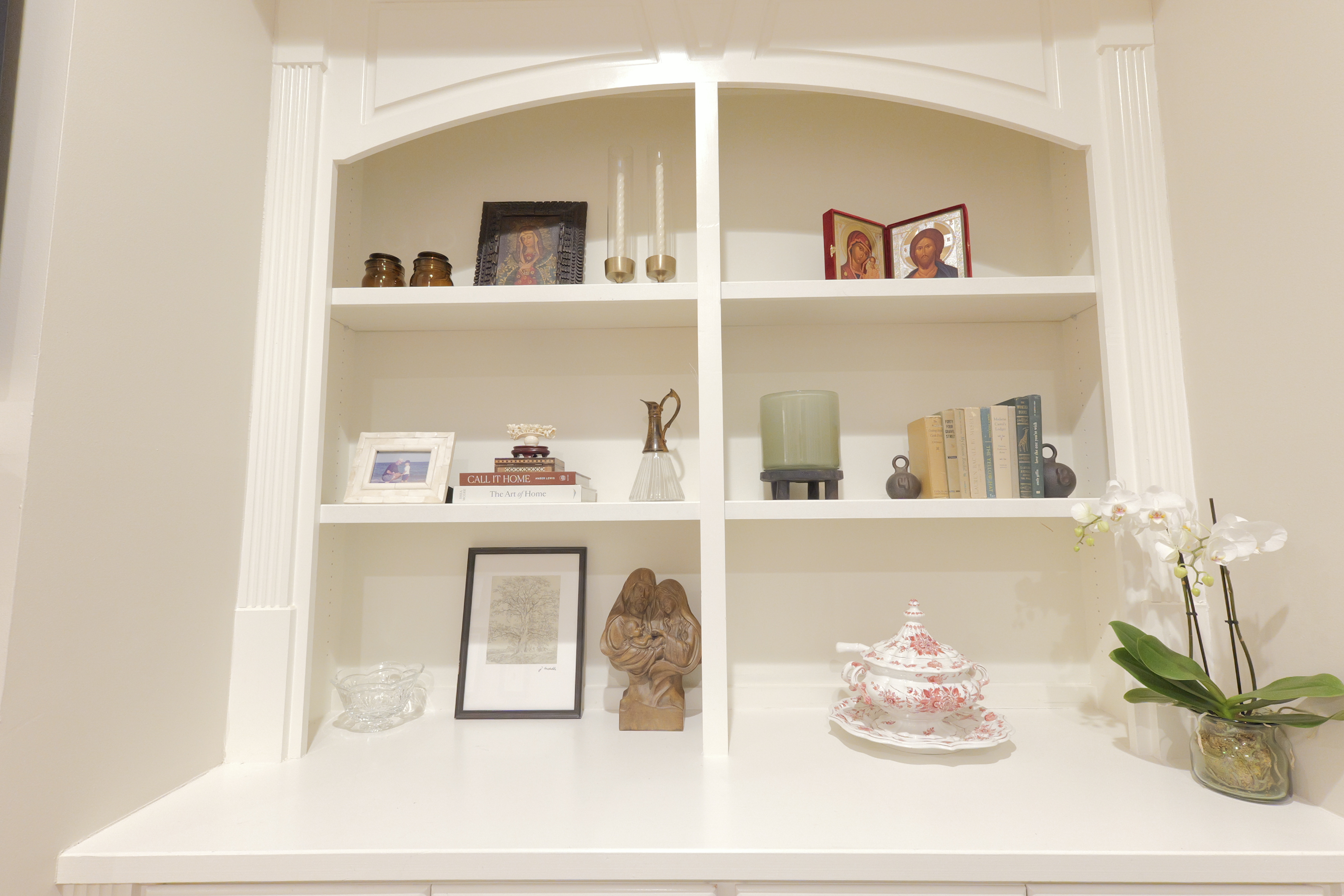 Arched built-in — icons, books, orchid and porcelain