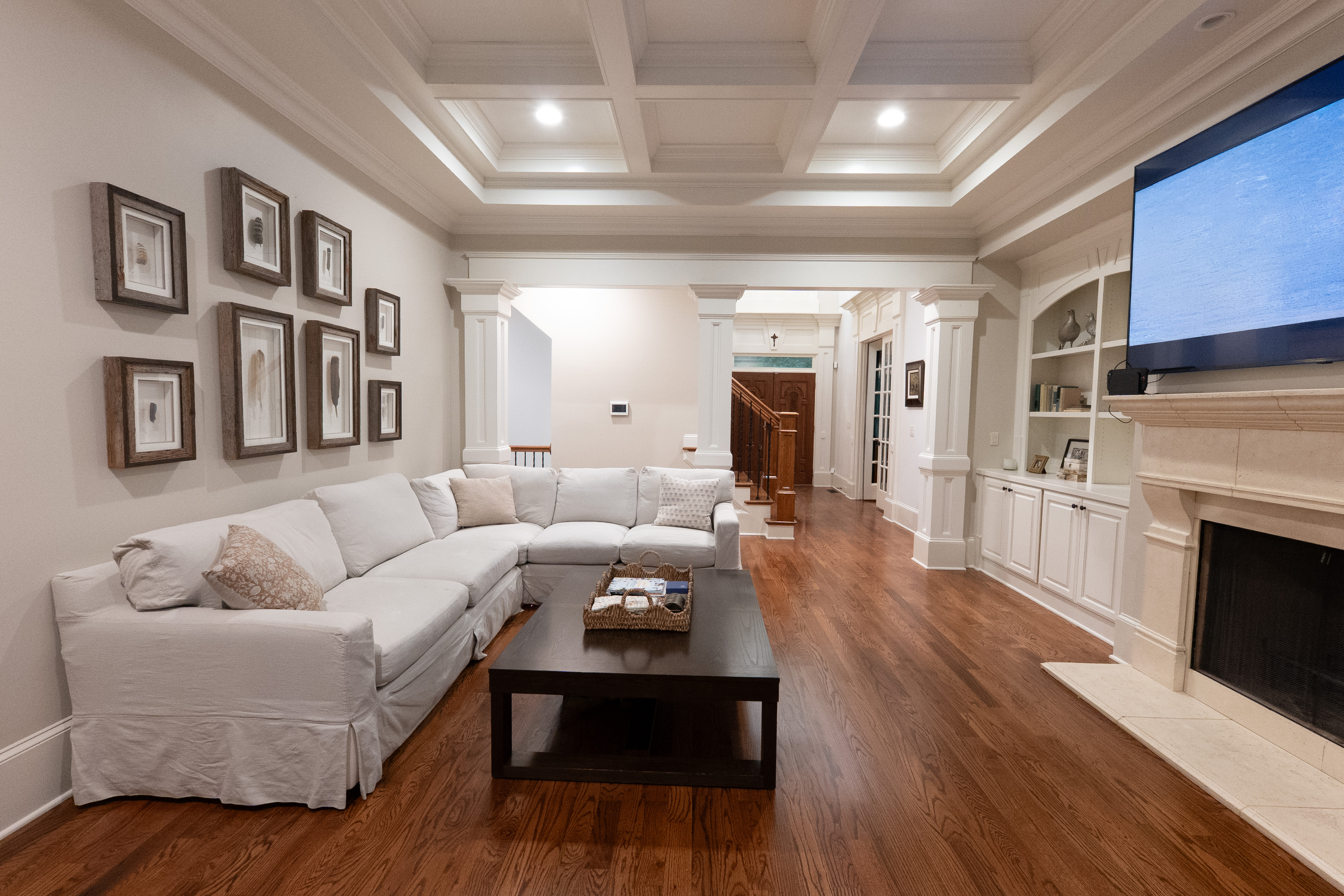 Living room — coffered ceiling, columns and bay shutters