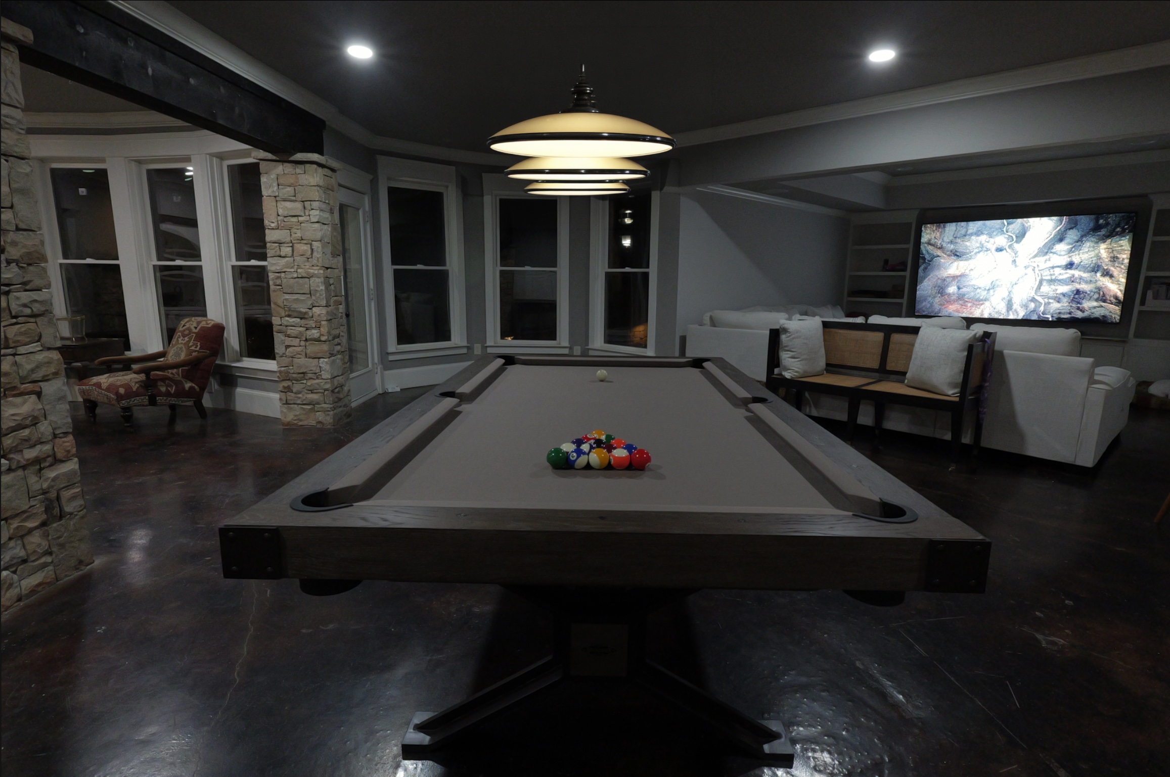 Basement — pool table, pendant light and 100-inch screen glowing